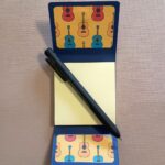 Guitar Notepad open with pen across
